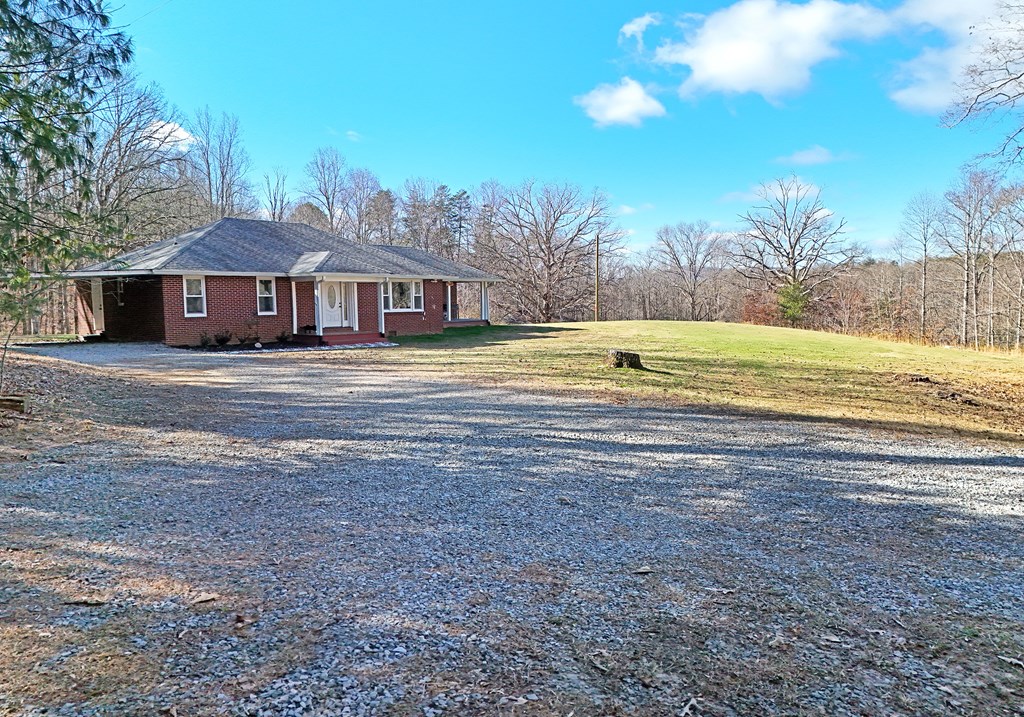 16894 Morganton Highway Morganton, GA 30560 - Photo 42 of 51 a view of a house with a yard and a large tree