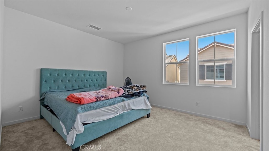 7044 Mallow Drive Mall, Unit 4 Fontana, CA 92336 - Photo 11 of 19 a bedroom with a bed and window