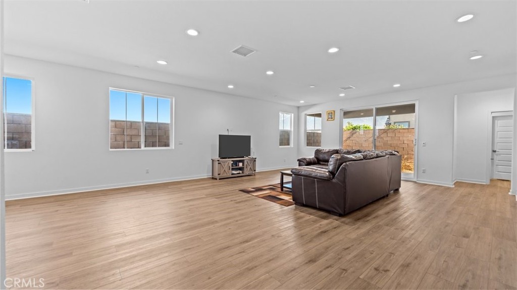 7044 Mallow Drive Mall, Unit 4 Fontana, CA 92336 - Photo 5 of 19 a living room with furniture and a flat screen tv