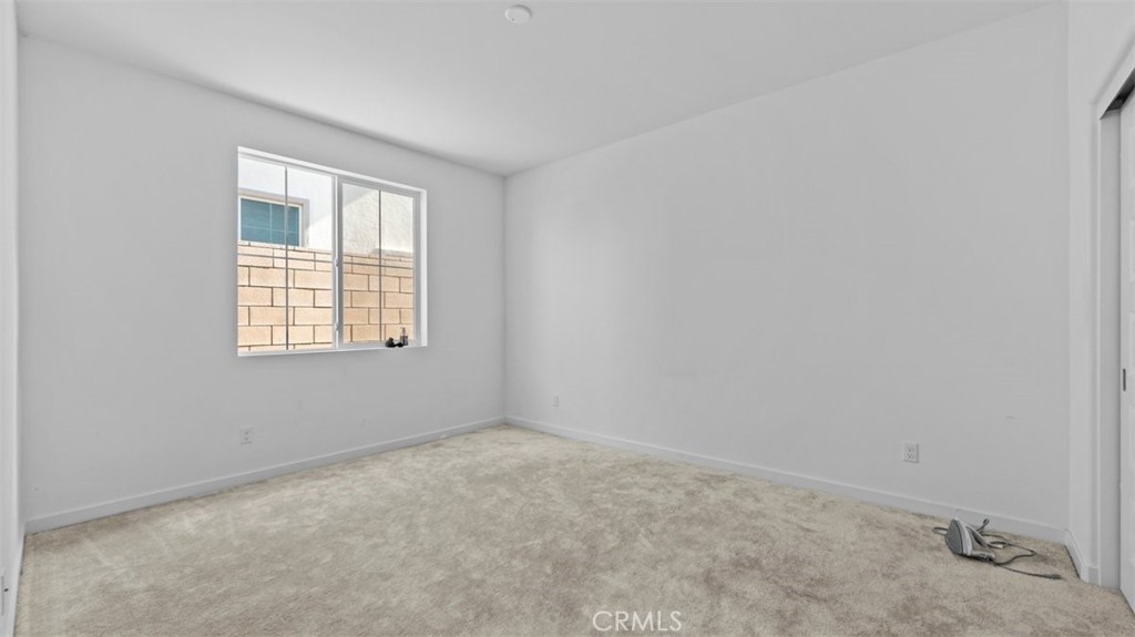 7044 Mallow Drive Mall, Unit 4 Fontana, CA 92336 - Photo 8 of 19 an empty room with a window