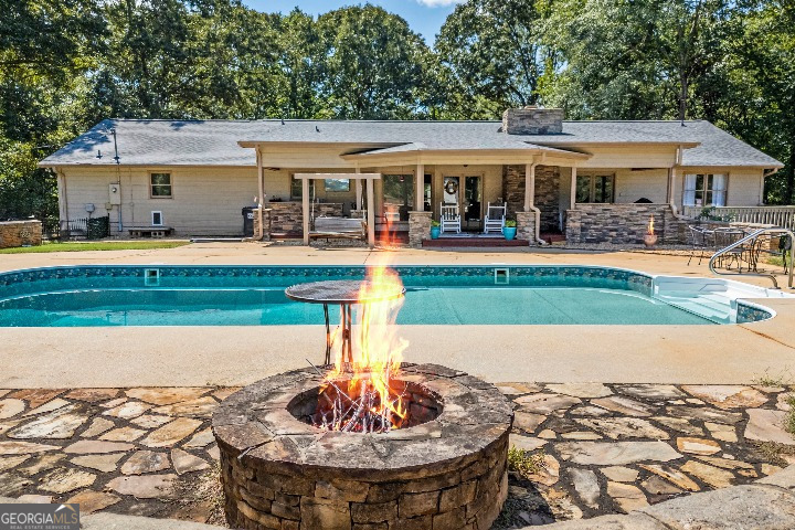 a view of a house with swimming pool and porch