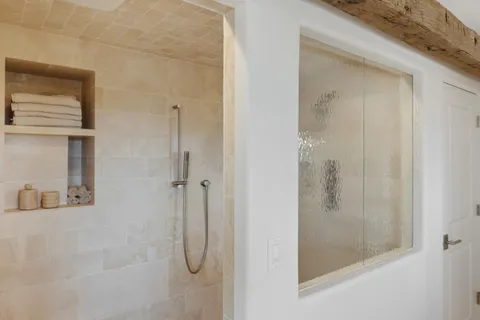 a bathroom with a bathtub and shower