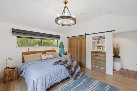 a bedroom with a bed and a painting on the wall