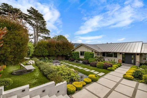 a view of a house with backyard sitting area and garden
