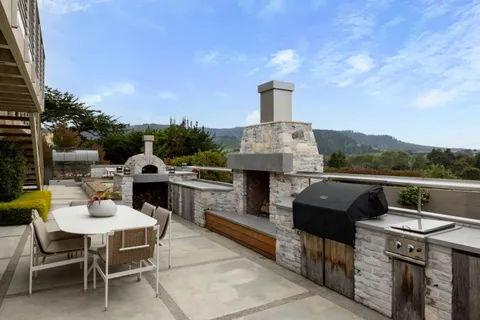 a view of a terrace with couches and sky view