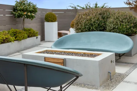 a view of a chair and tables front of the house
