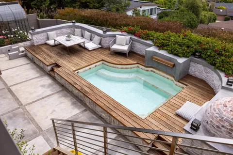 a view of backyard with table and chairs and potted plants
