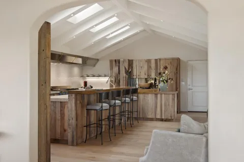 a kitchen with stainless steel appliances granite countertop a sink a stove and a wooden floors