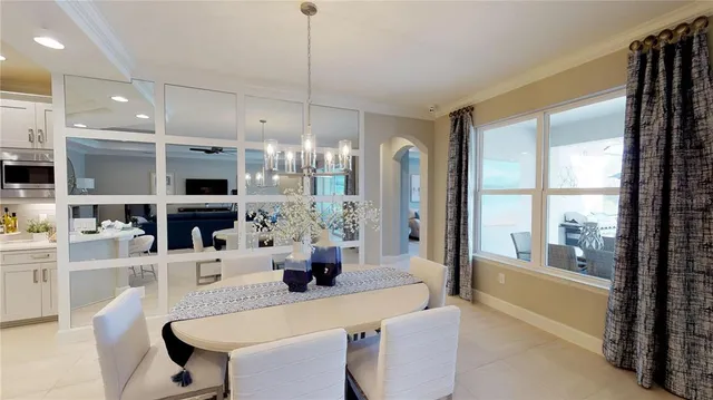 a large kitchen with a table chairs refrigerator and cabinets