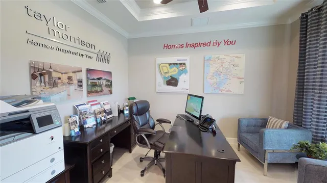 a view of a workspace with furniture and a window