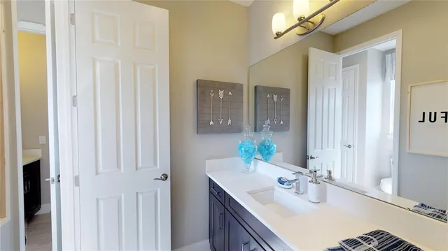 a bathroom with a double vanity sink and a mirror