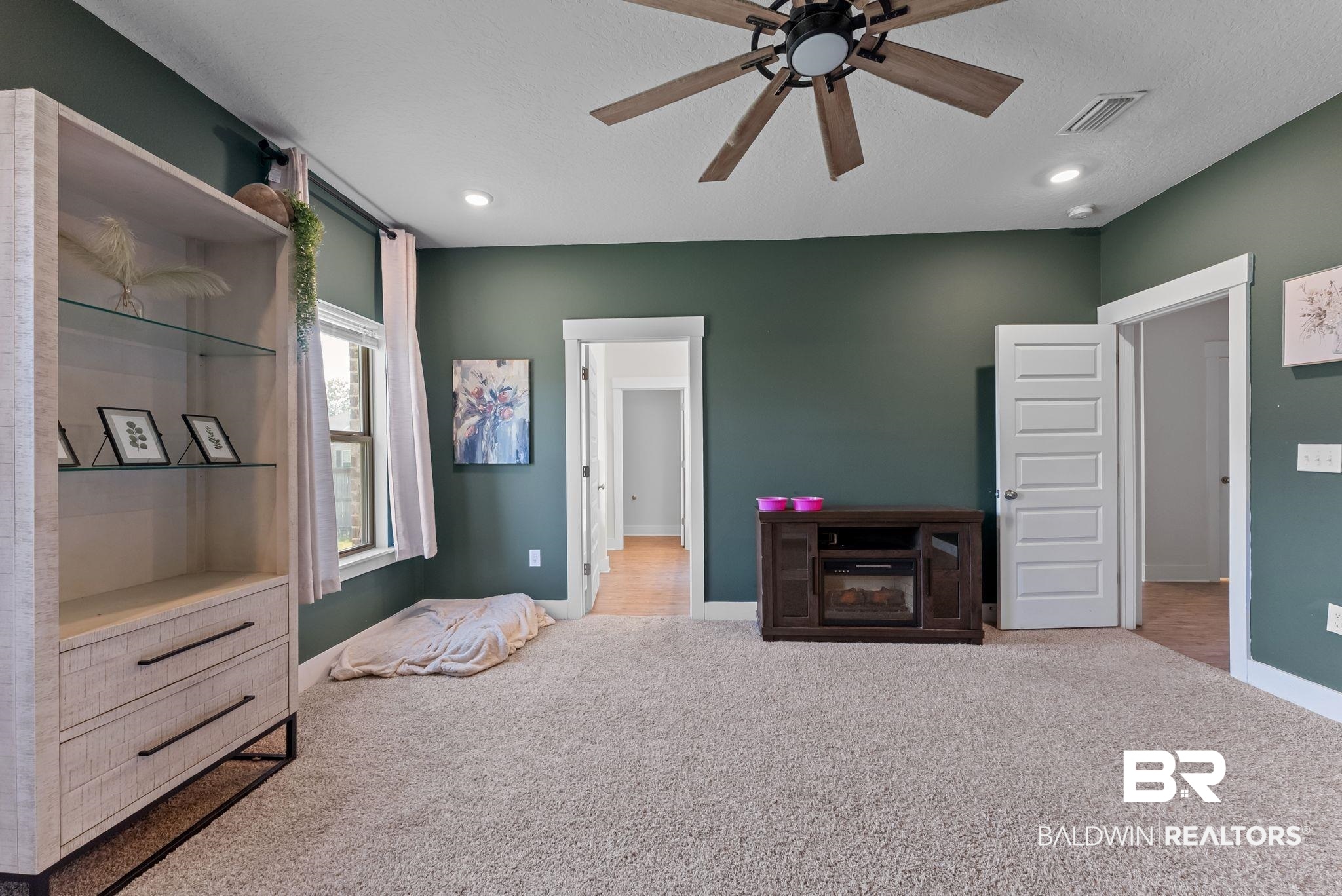 16607 Prado Loop Loxley, AL 36551 - Photo 30 of 46 Spacious room featuring plush carpeting and dark green wall finishes