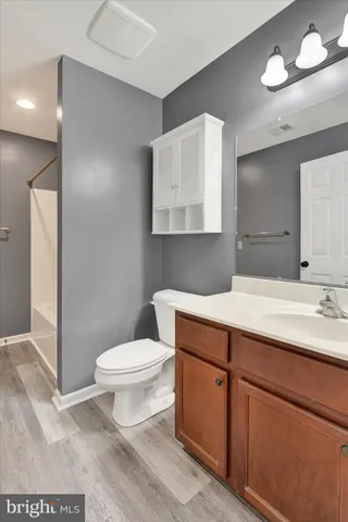 a bathroom with a sink a toilet and mirror