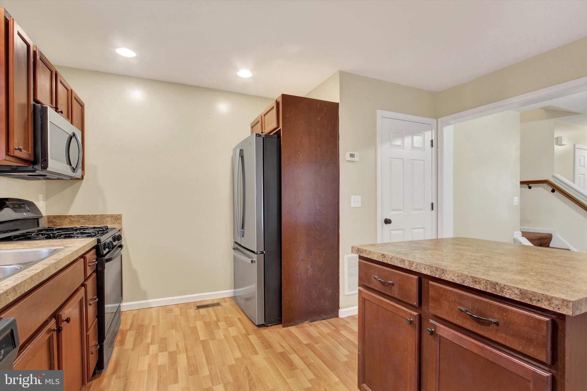 58 Skyview Circle Hanover, PA 17331 - Photo 10 of 31 a kitchen with stainless steel appliances granite countertop a refrigerator a stove and a sink with wooden floor