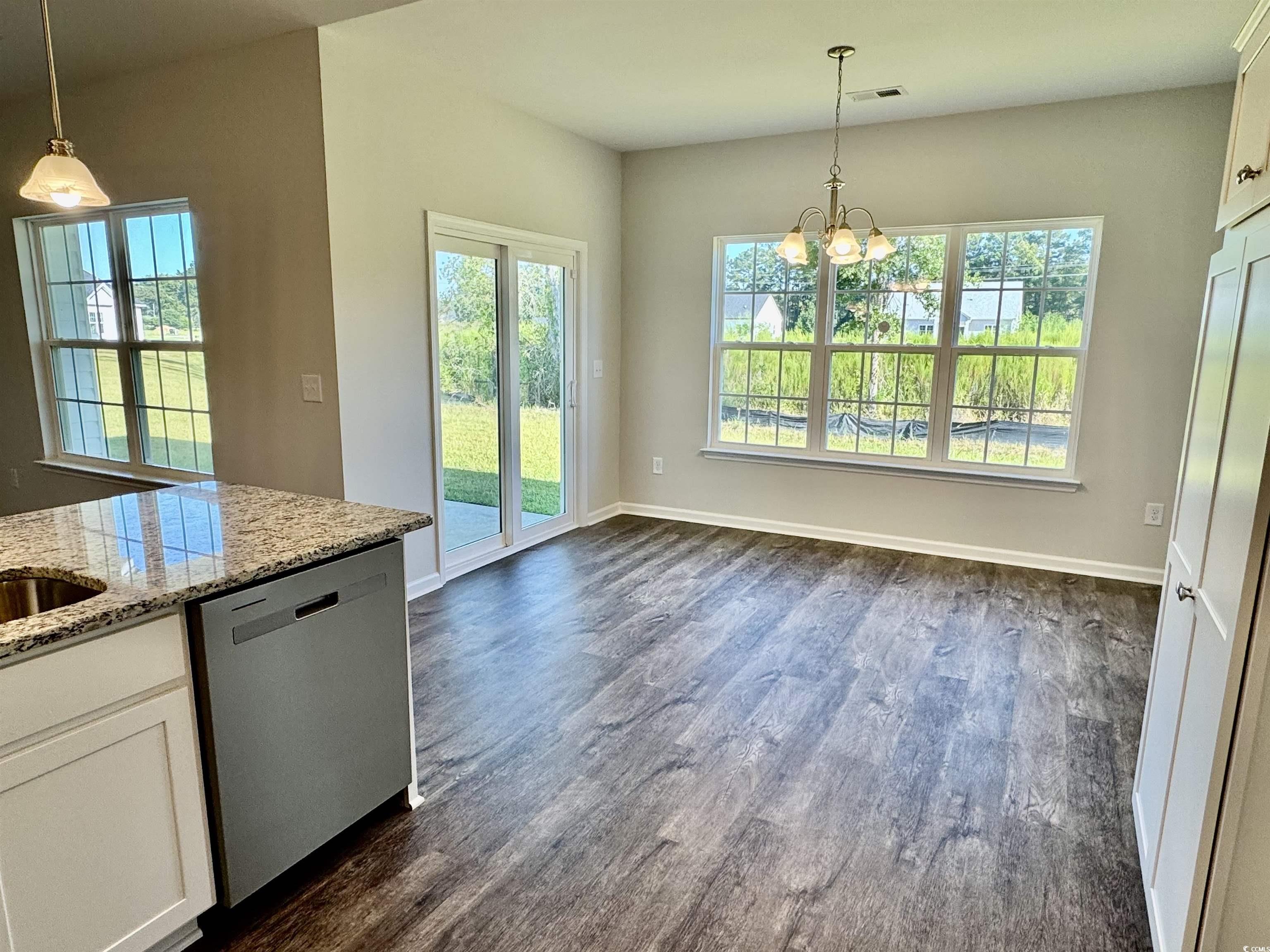 594 Shallow Cv Drive Conway, SC 29527 - Photo 11 of 29 Unfurnished dining area with dark wood-type floori