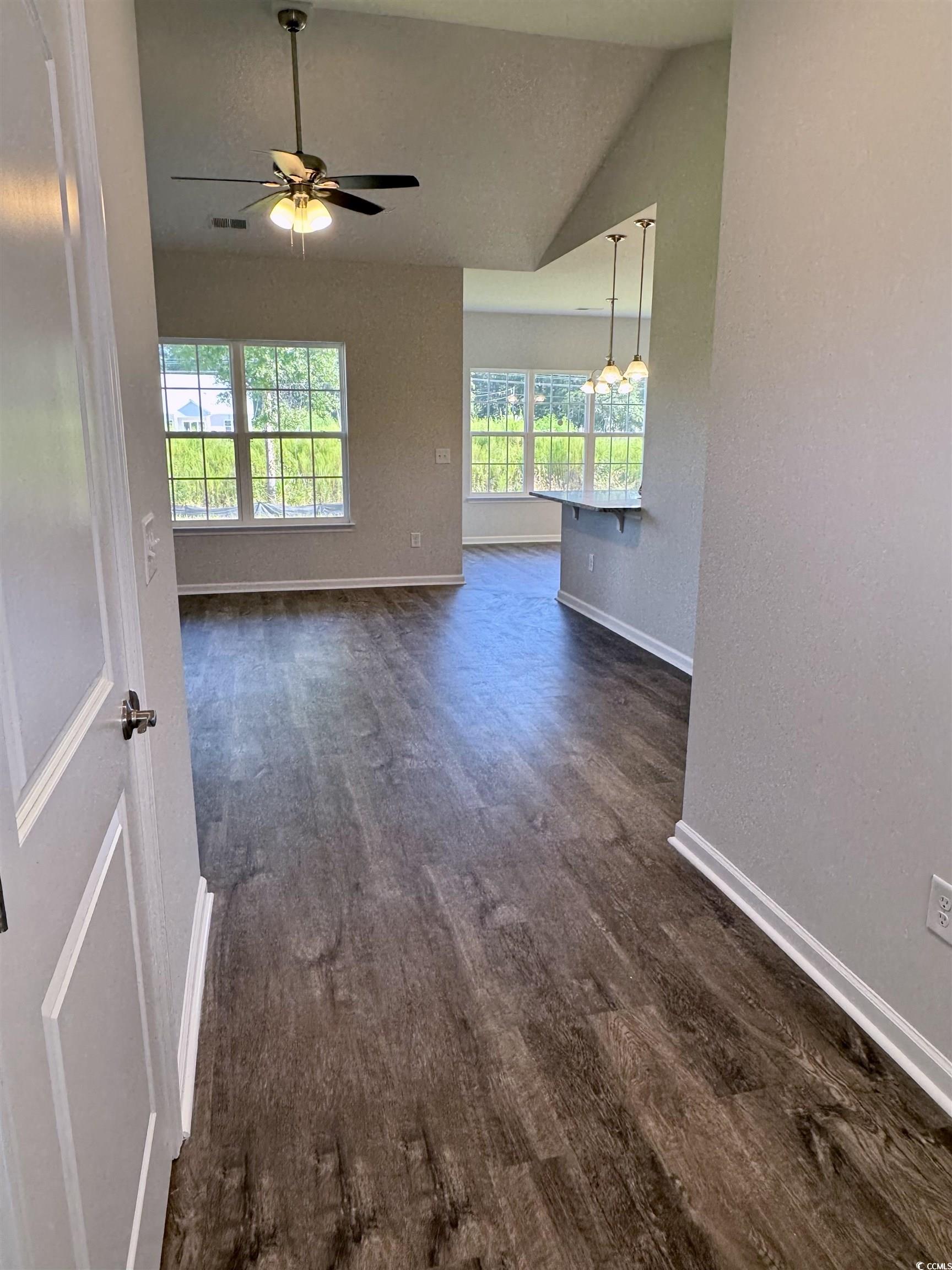 594 Shallow Cv Drive Conway, SC 29527 - Photo 27 of 29 Empty room featuring lofted ceiling, dark wood-sty