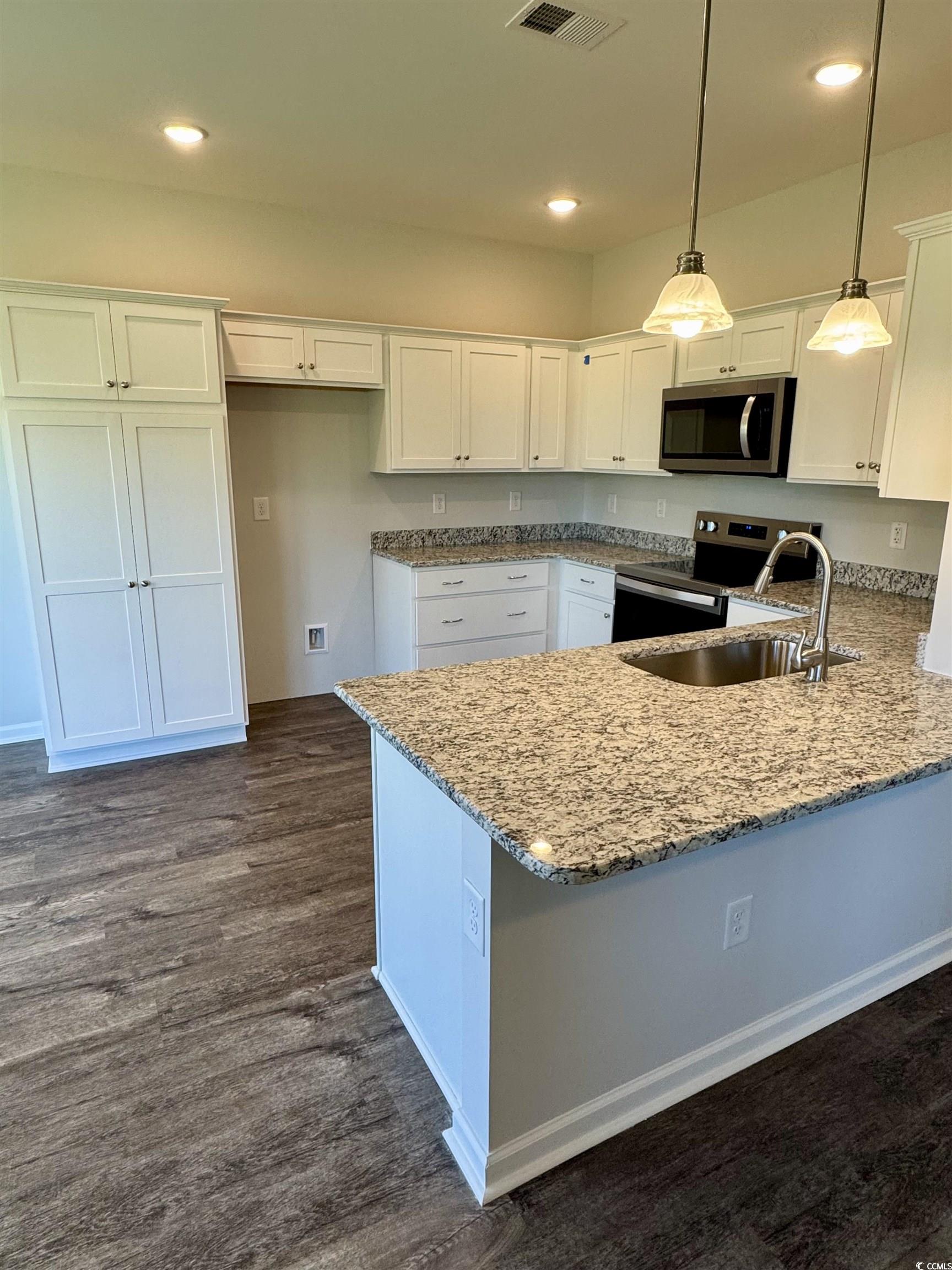594 Shallow Cv Drive Conway, SC 29527 - Photo 9 of 29 Kitchen featuring white cabinets, stainless steel