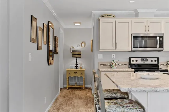 a kitchen with stainless steel appliances granite countertop a refrigerator sink and stove