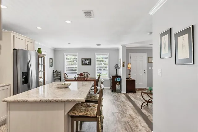 a kitchen with stainless steel appliances granite countertop a refrigerator and a sink