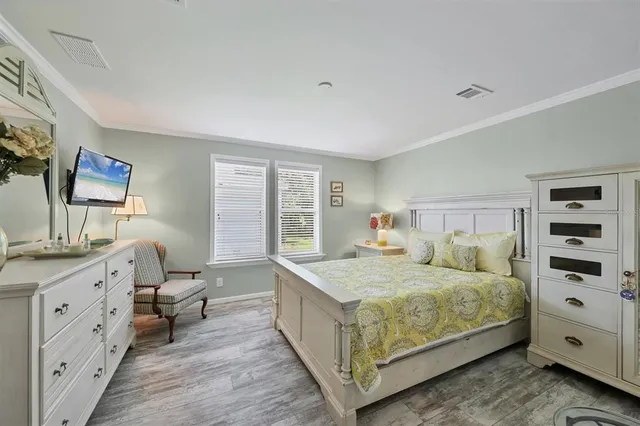 a bedroom with a bed and a dresser in it