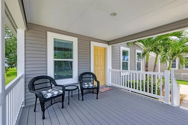 a view of a balcony with furniture and floor to ceiling windows