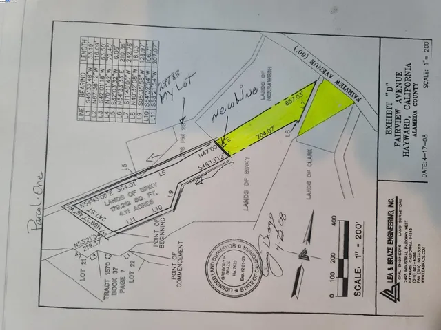 a yellow and white umbrella sitting in front of a house