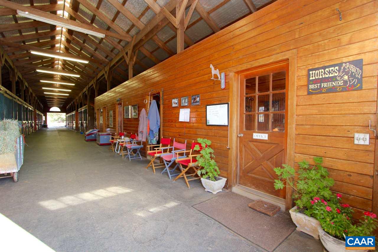 6080-6082 Amicus Road Ruckersville, VA 22968 - Photo 5 of 22 a view of a garage with a table and chairs and potted plants