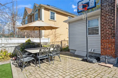 a backyard of a house with table and chairs