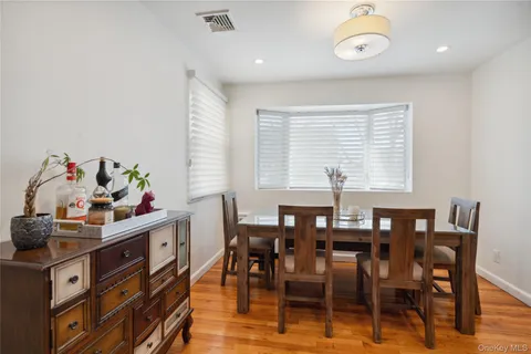 a view of a dining room with furniture and window