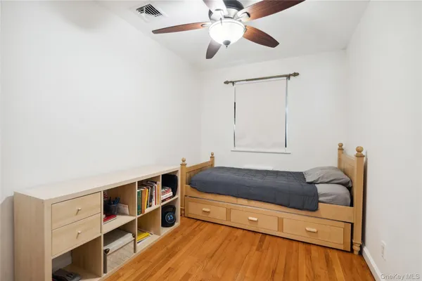 a living room with furniture and a baby crib