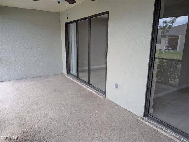 a front view of a house with a yard and potted plants