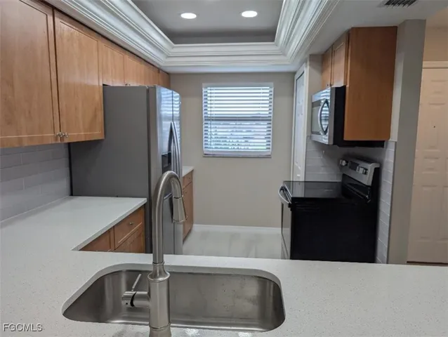 a kitchen with a refrigerator and a sink