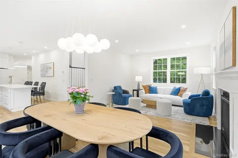 a living room with furniture potted plant and a chandelier