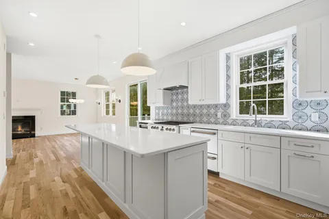 a large kitchen with cabinets and wooden floor