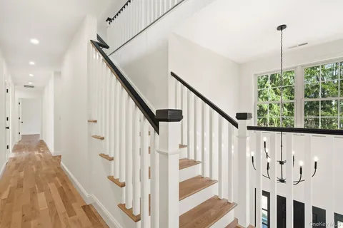 a view of entryway with wooden floor and stairs