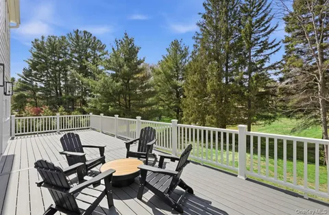 a view of a patio on wooden deck and a backyard
