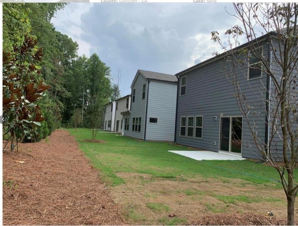 2979 Morgan Spring Trail Buford, GA 30519 - Photo 11 of 21 a view of a house with a yard and large tree