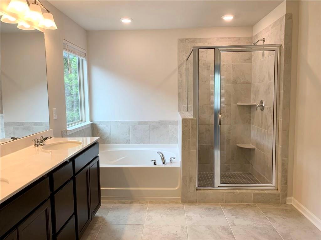 2979 Morgan Spring Trail Buford, GA 30519 - Photo 3 of 21 a bathroom with a bathtub and a sink