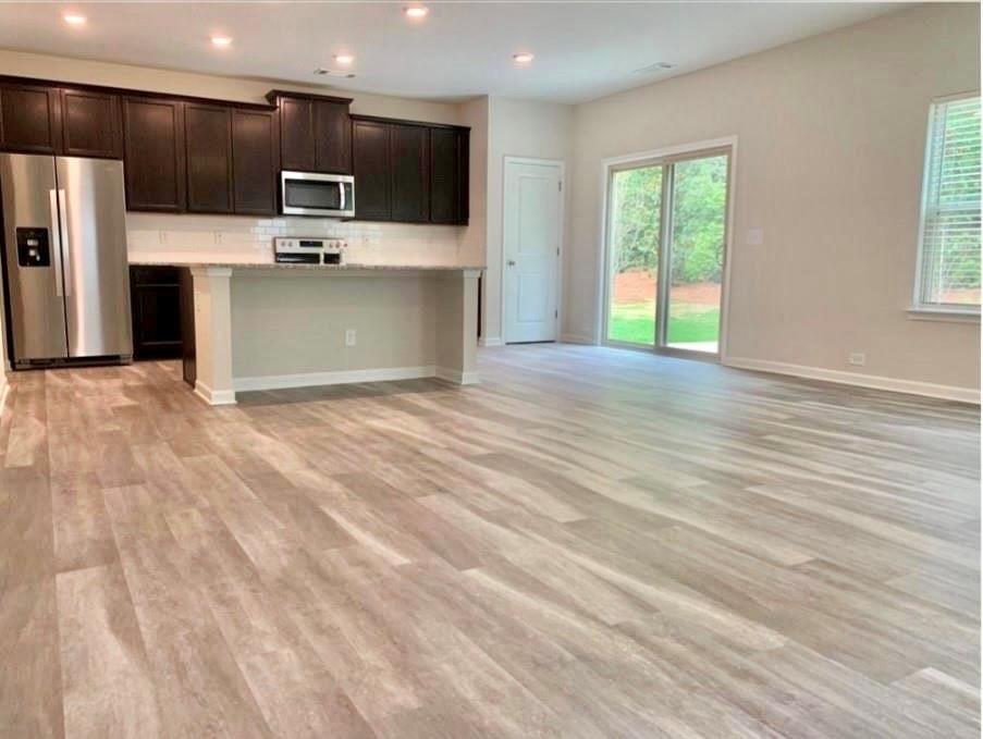 2979 Morgan Spring Trail Buford, GA 30519 - Photo 4 of 21 a view of kitchen stainless steel appliances wooden floor and a window