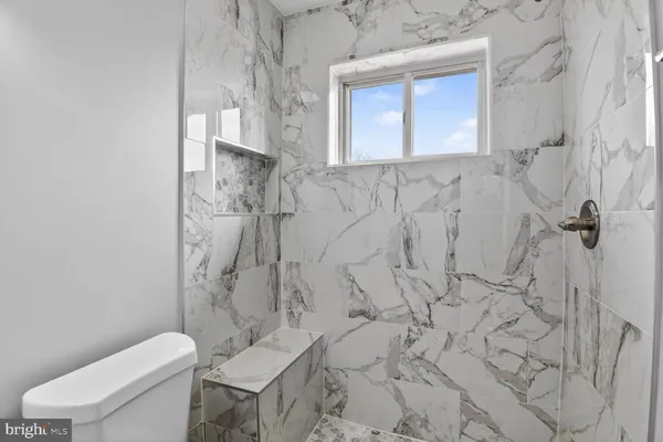 a bathroom with a toilet sink and shower