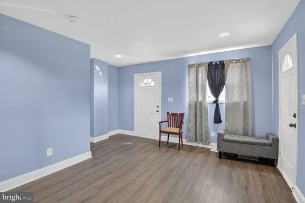 a view of entryway with wooden floor and furniture