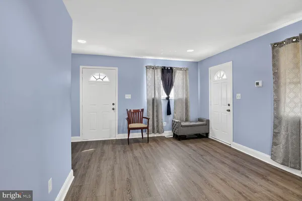 a view of an empty room and wooden floor