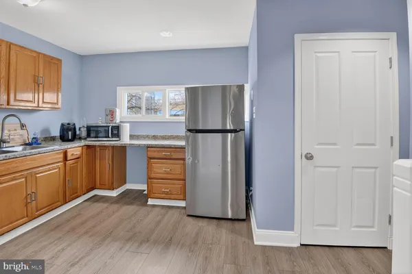 a kitchen with a refrigerator stove and sink