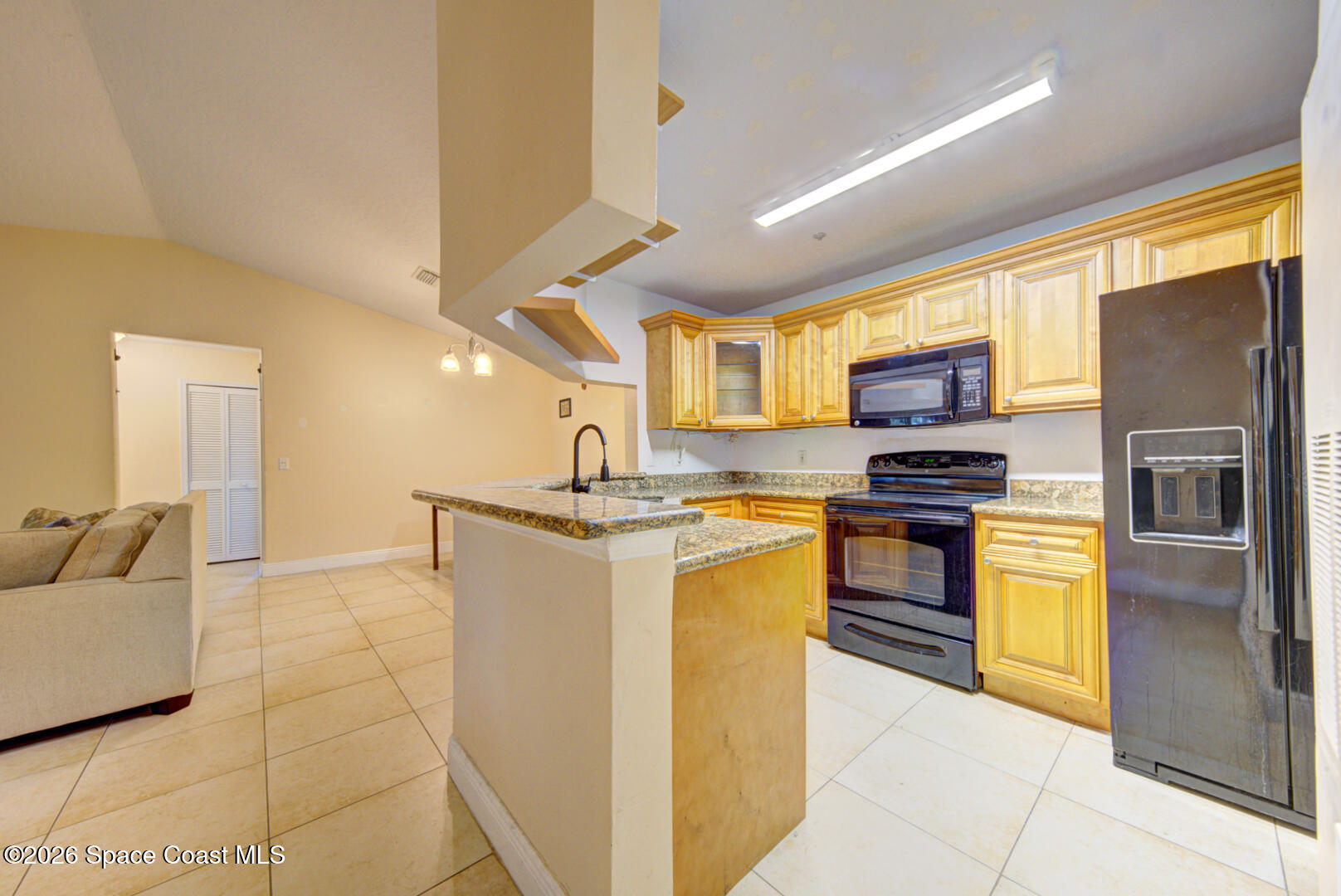 7667 North Wickham Road, Unit 1416 Melbourne, FL 32940 - Photo 5 of 41 a kitchen with stainless steel appliances granite countertop a refrigerator and a stove top oven