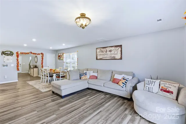 a living room with stainless steel appliances kitchen island granite countertop furniture and a fireplace
