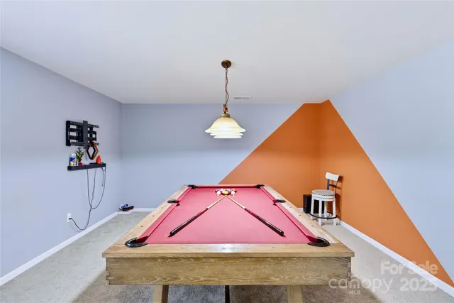 a room with pool table and windows