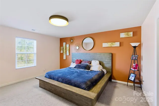 a bedroom with a bed and flat screen tv