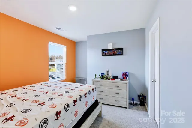 a bedroom with a bed and windows