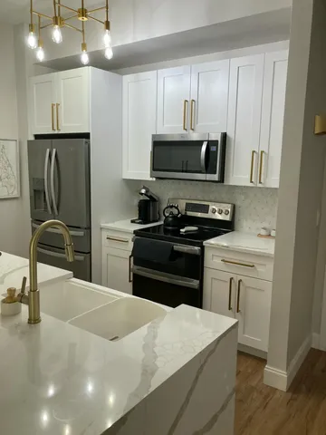 a kitchen with a sink and a refrigerator