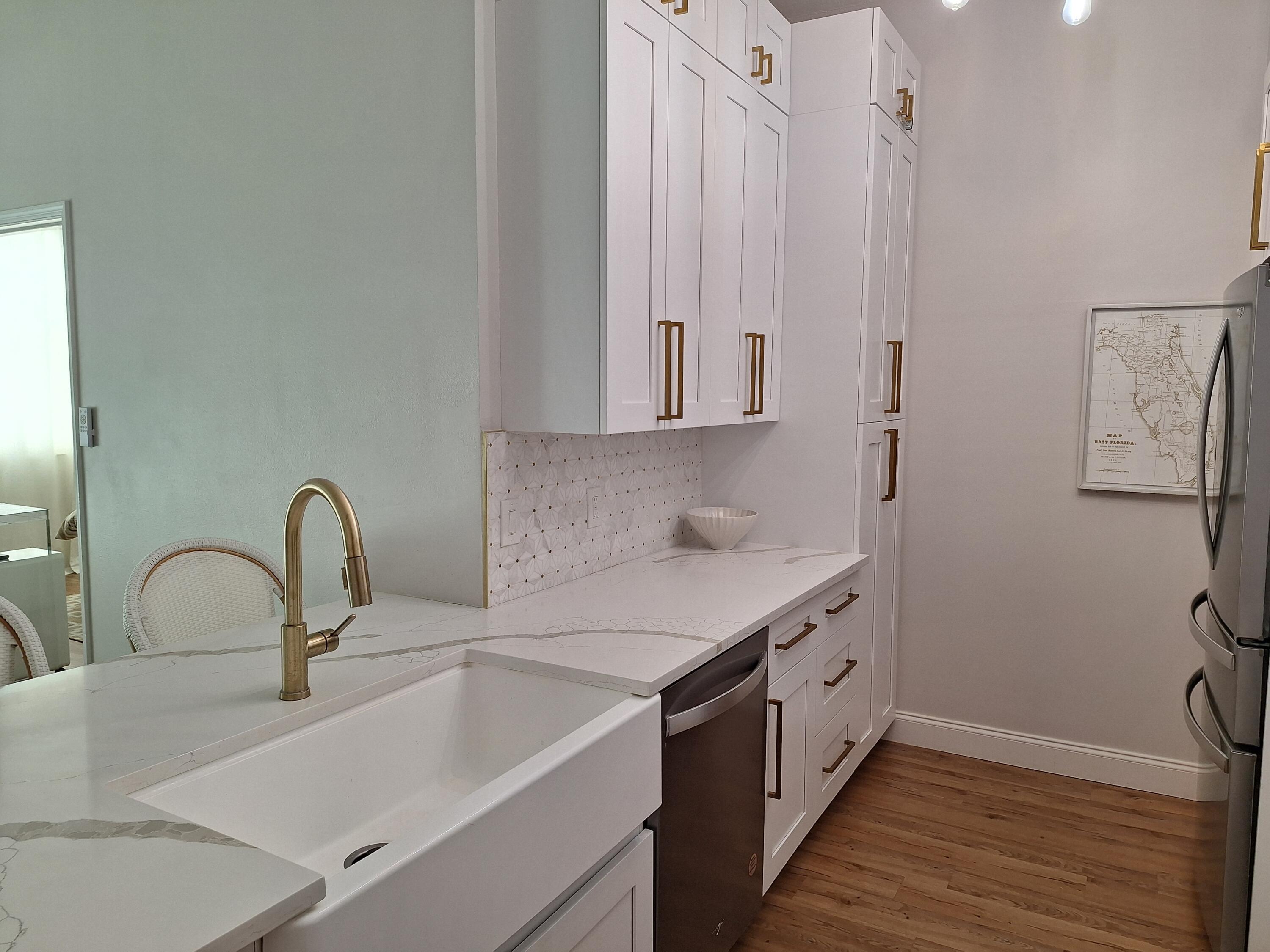 804 East Windward Way, Unit PH 21 Lantana, FL 33462 - Photo 13 of 46 a kitchen with a sink and a refrigerator